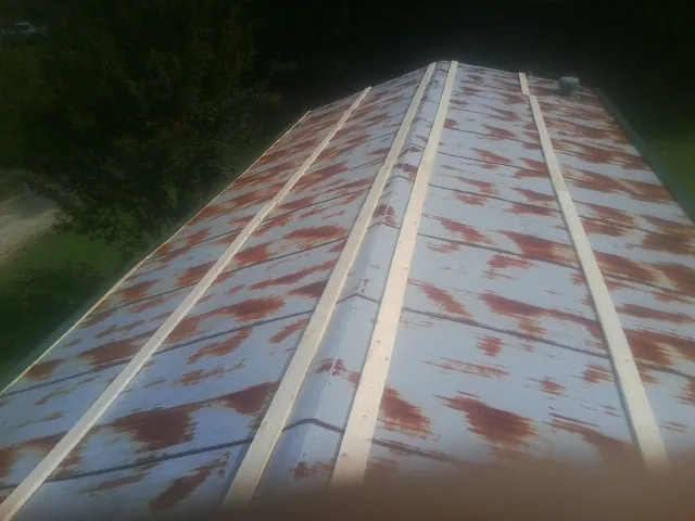 Rusted metal roof panels with new wood purlins before replacement — Storm Damage Roof Repair in Waynesboro by Roofing Brothers