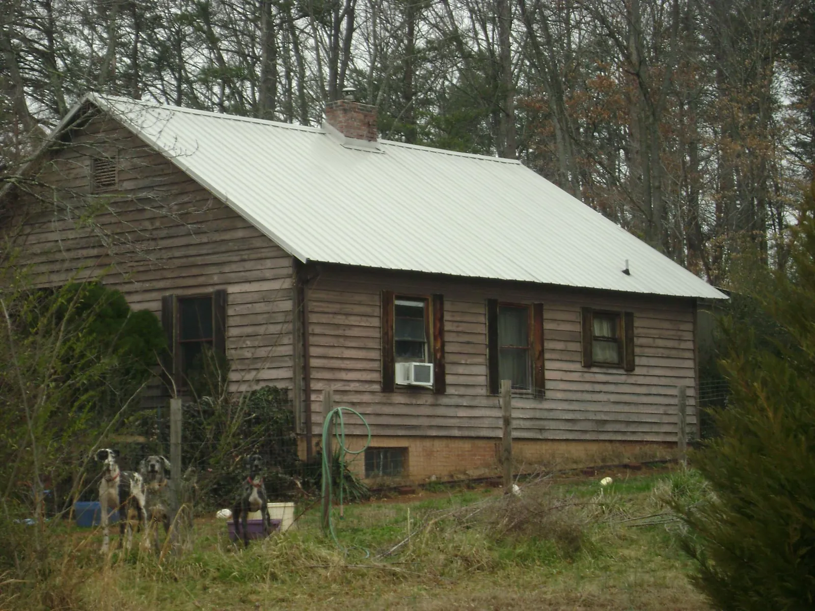 White metal roof on an old wood sided farmhouse, from a Metal Roof Installation job in Waynesboro